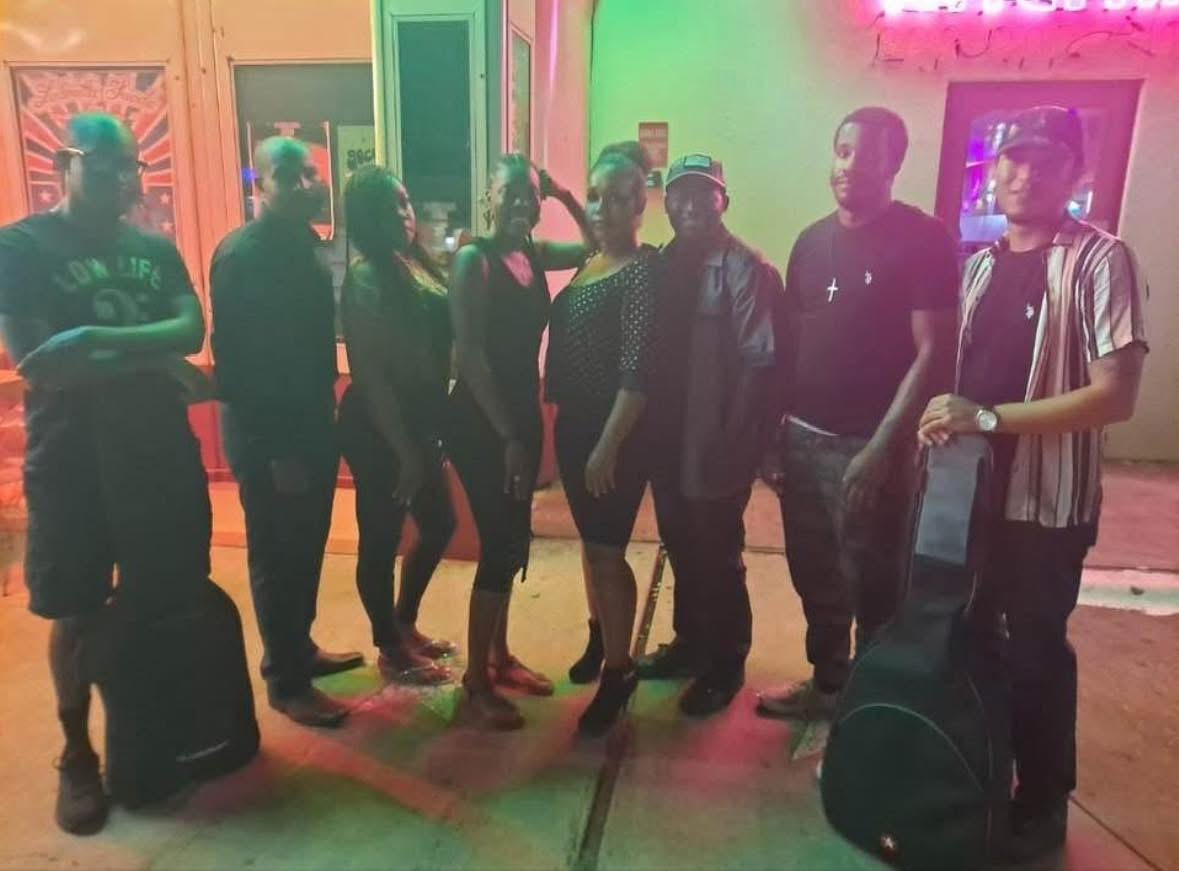 The band together at a night event